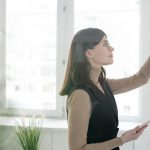 elegant-coach-with-smartphone-writing-down-on-whiteboard-during-presentation.jpg