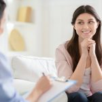 smiling-woman-talking-to-wellness-coach-about-motivation.jpg