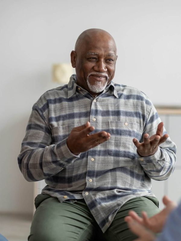 cheerful-african-american-elderly-man-having-conversation-with-coach.jpg